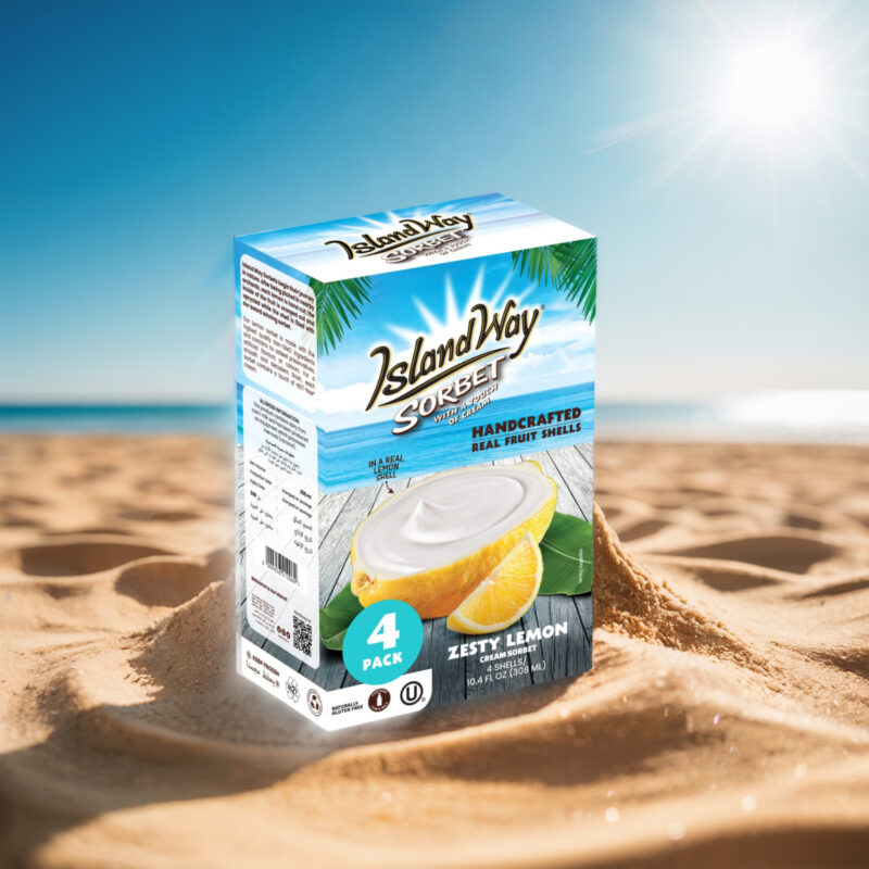 Pack de 4 sorbets Island Way Zesty Lemon dans des coques de citron, posé sur le sable avec fond marin ensoleillé
